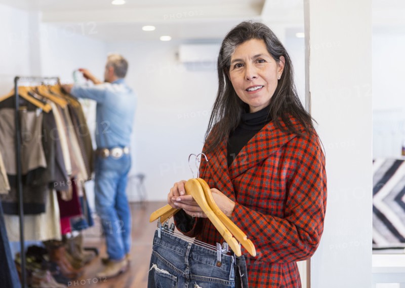 Woman shopping for jeans in clothing store