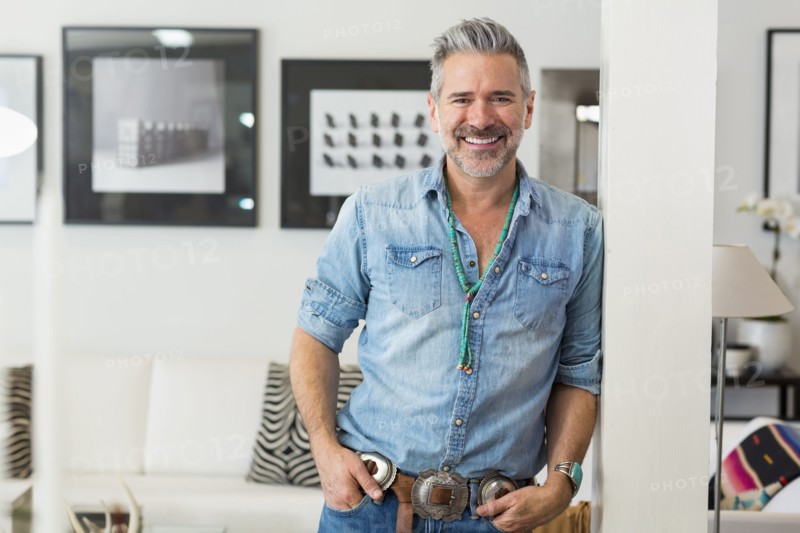 Smiling Caucasian man leaning on pillar