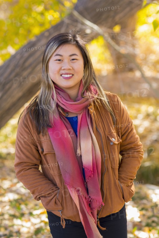 Portrait of smiling Asian woman in autumn