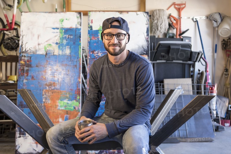 Portrait of Caucasian man sitting on metal sculpture