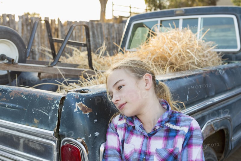 Caucasian girl leaning on truck