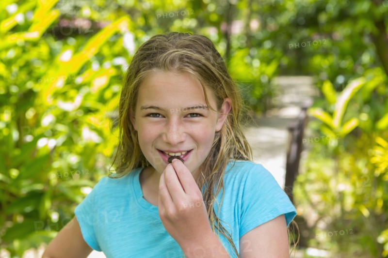 Caucasian girl eating snack