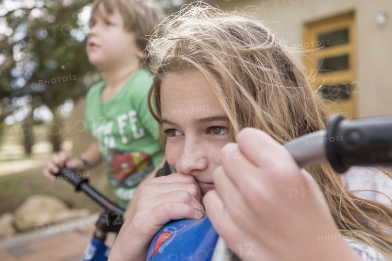 Wind blowing hair of Caucasian girl on bicycle