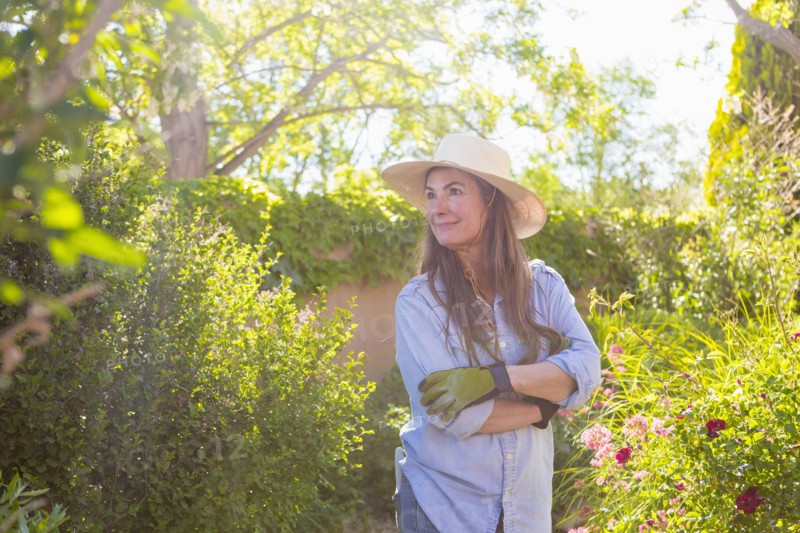 Older Caucasian woman admiring flowers in garden