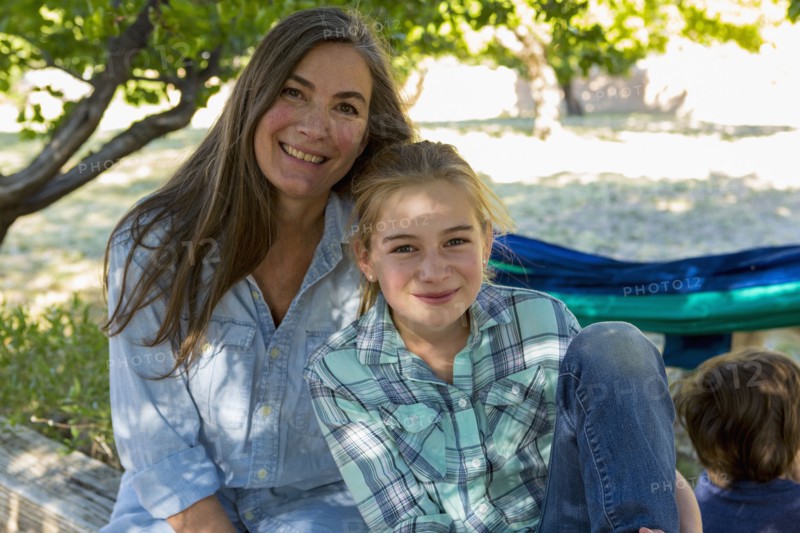 Caucasian grandmother posing with granddaughter