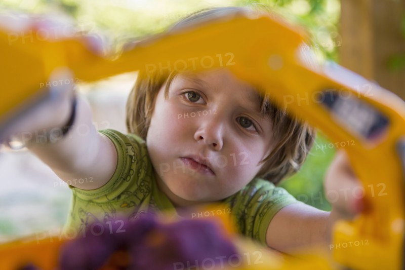 Caucasian boy playing with construction toilet