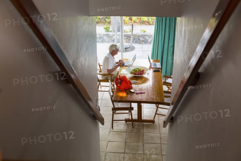 Caucasian man using laptop near staircase