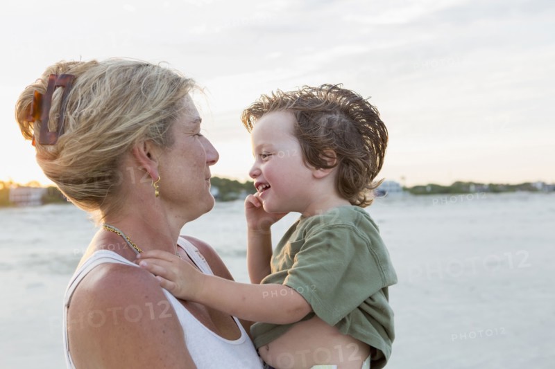 Caucasian mother holding boy at beach
