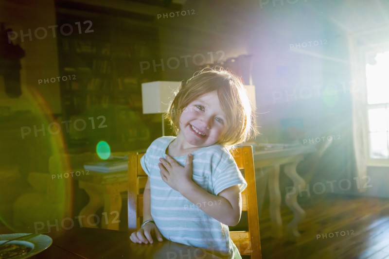 Sunshine on Caucasian boy sitting at table