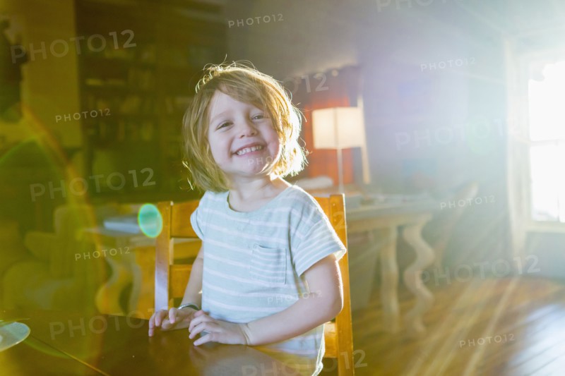Sunshine on Caucasian boy sitting at table