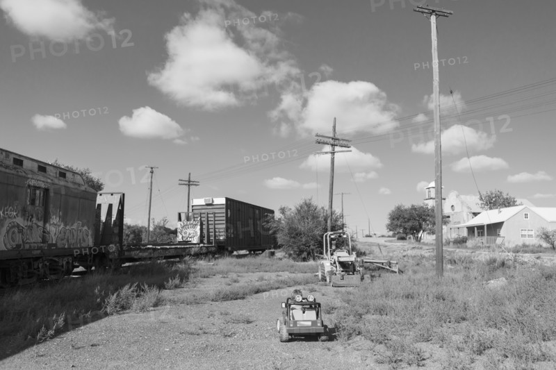 Caucasian boy driving toy car near train