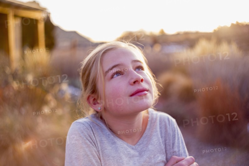 Curious Caucasian girl looking up outdoors