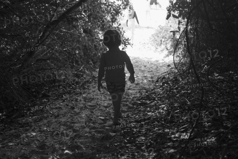 Caucasian boy walking on sandy path