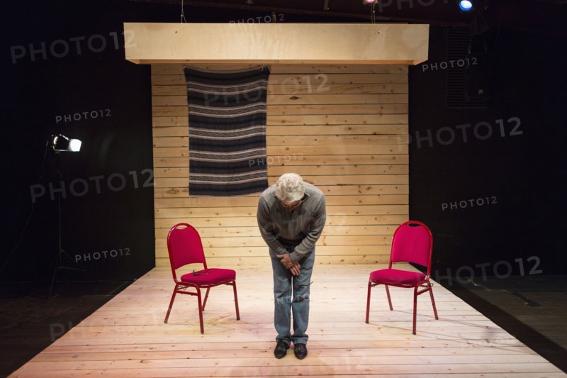 Hispanic man bowing on theater stage