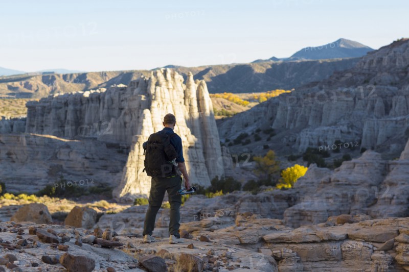 Caucasian man carrying backpack in desert