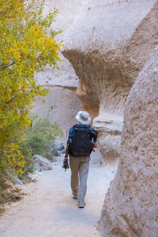 Caucasian man hiking near boulders