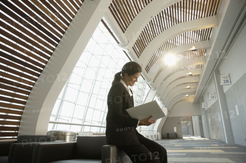 Businesswoman reading paperwork in conference room