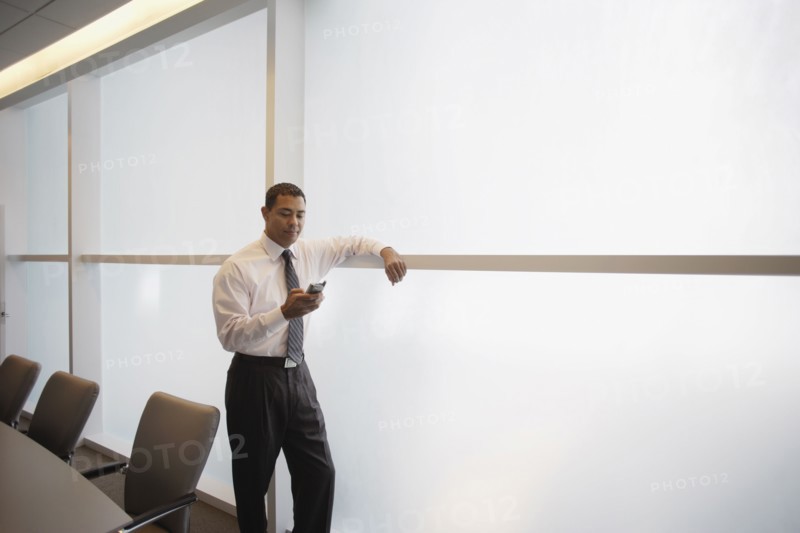 Hispanic businessman looking at electronic organizer
