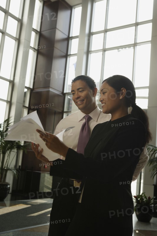 Multi-ethnic businesspeople looking at paperwork