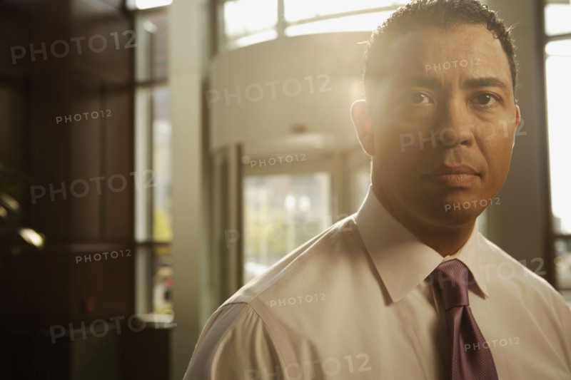 Portrait of Hispanic businessman in sunlight