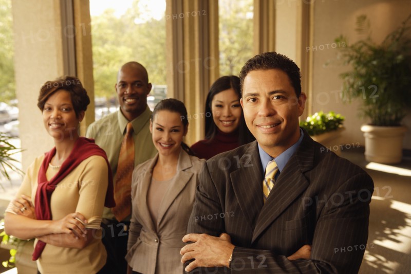 Hispanic businessman in front of coworkers