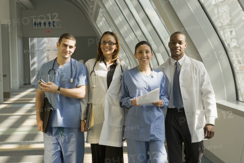 Multi-ethnic doctors and nurses posing in corridor