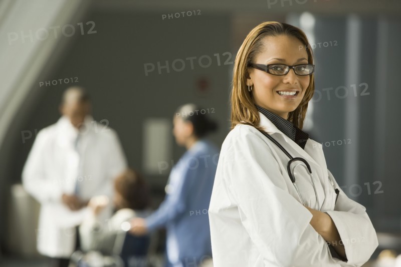 African doctor with arms crossed smiling