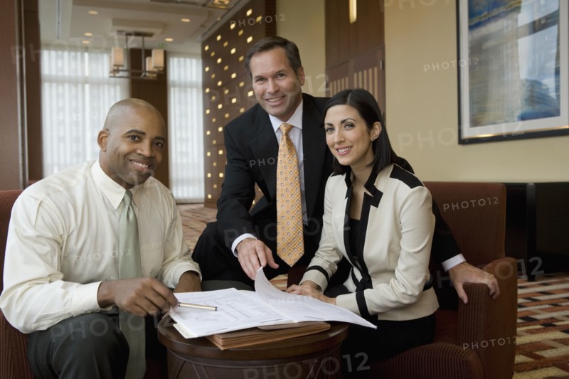 Multi-ethnic business people posing in lobby