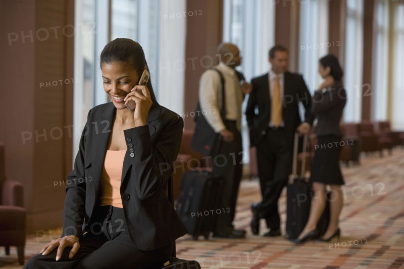 African businesswoman talking on cell phone