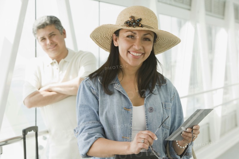 Hispanic couple waiting in airport