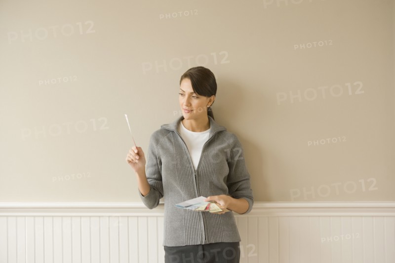 Hispanic woman holding color swatches