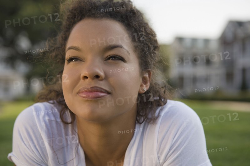 Mixed race woman looking up outdoors