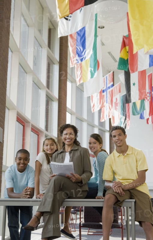 Teacher and students posing in classroom