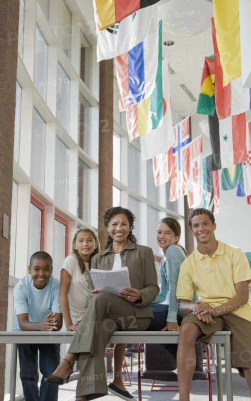 Teacher and students posing in classroom