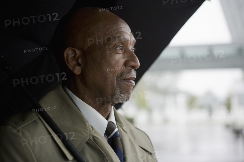 African businessman holding umbrella