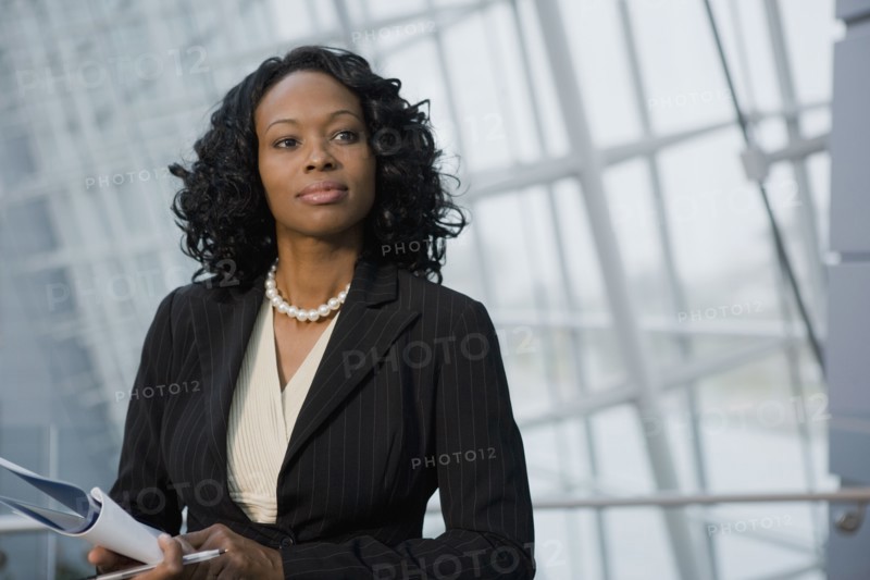African businesswoman holding paperwork
