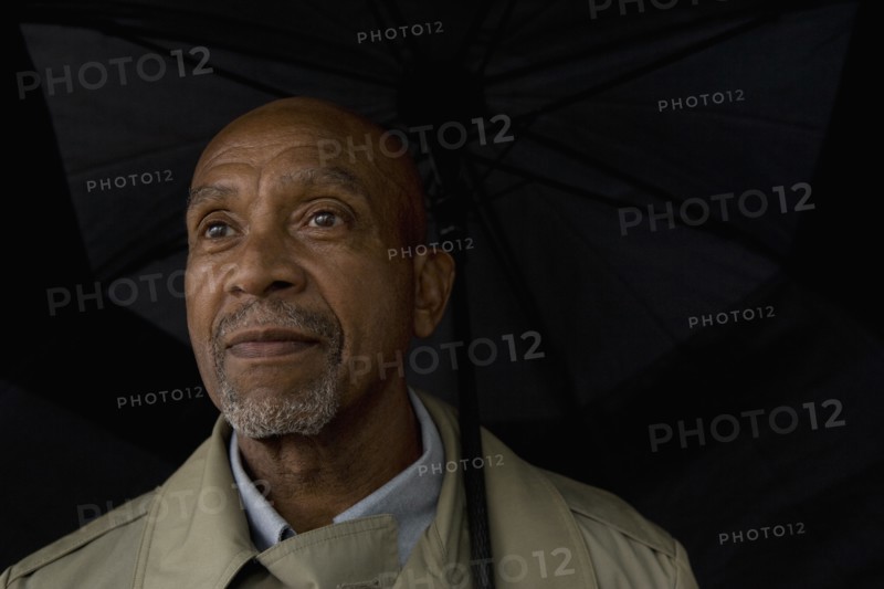 African businessman holding umbrella