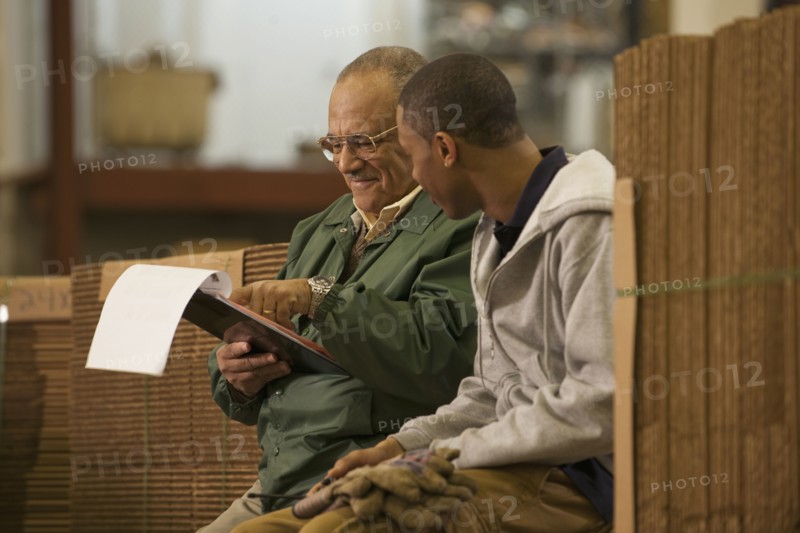 Manager talking with worker in warehouse