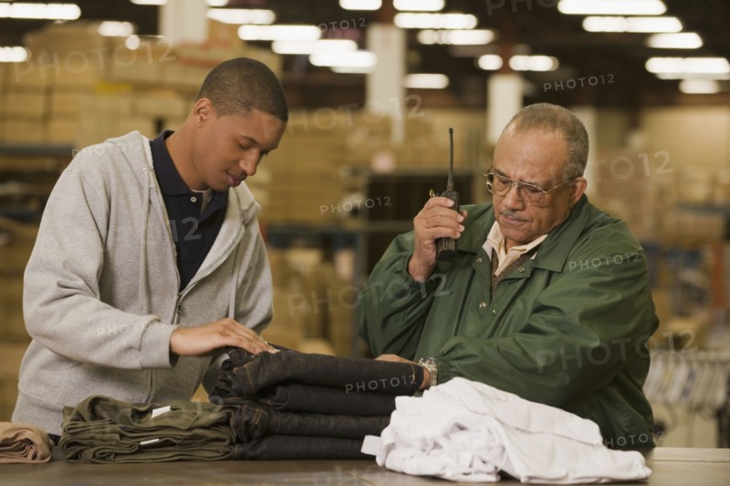 Manager talking with worker in warehouse