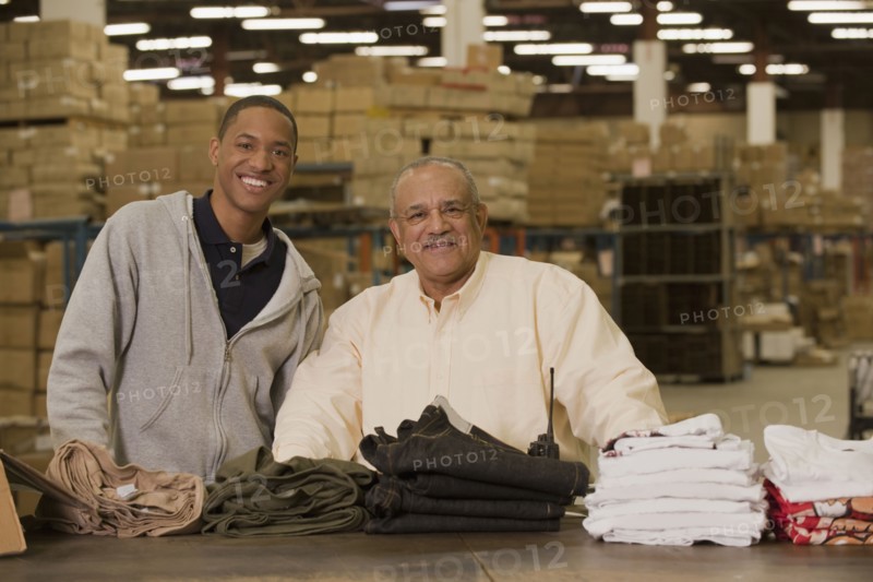 Manager standing with worker in warehouse