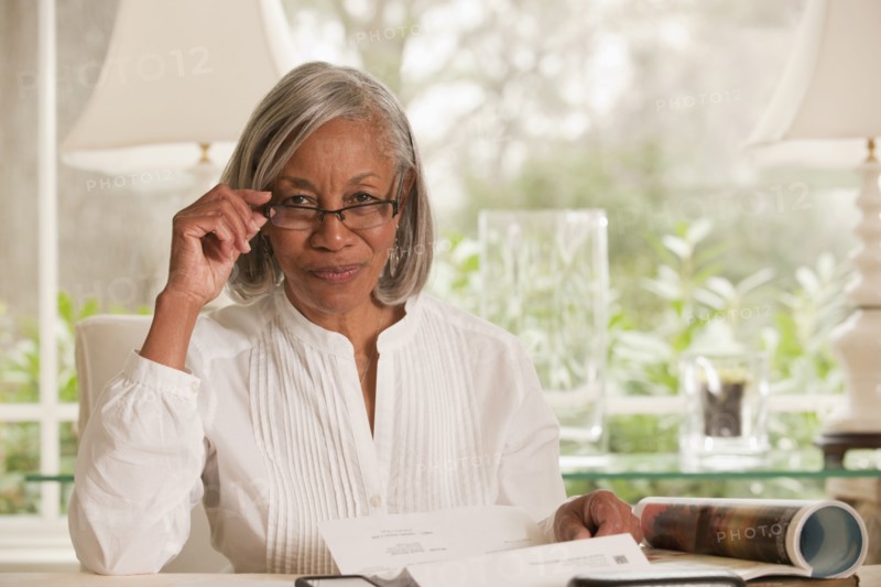 Black woman adjusting eyeglasses