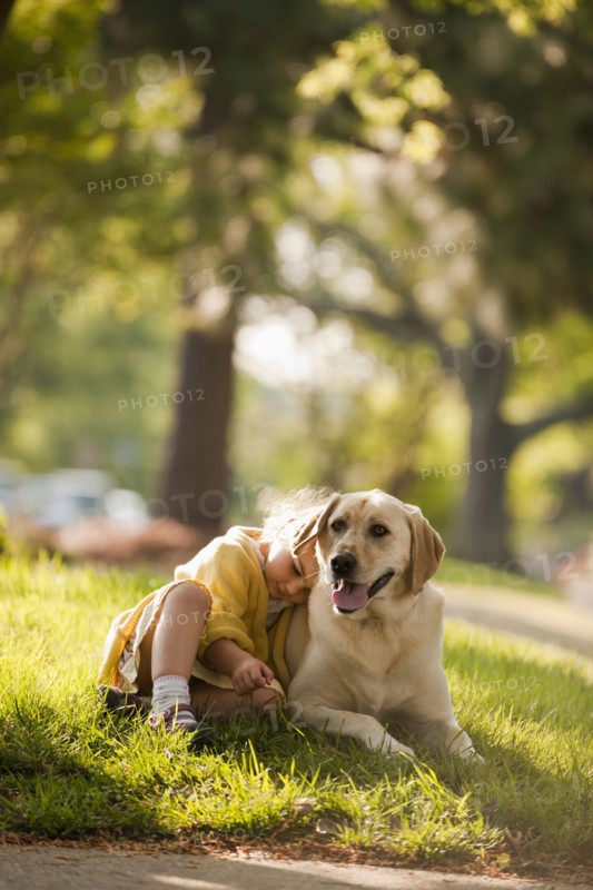 Caucasian girl playing with dog in yard