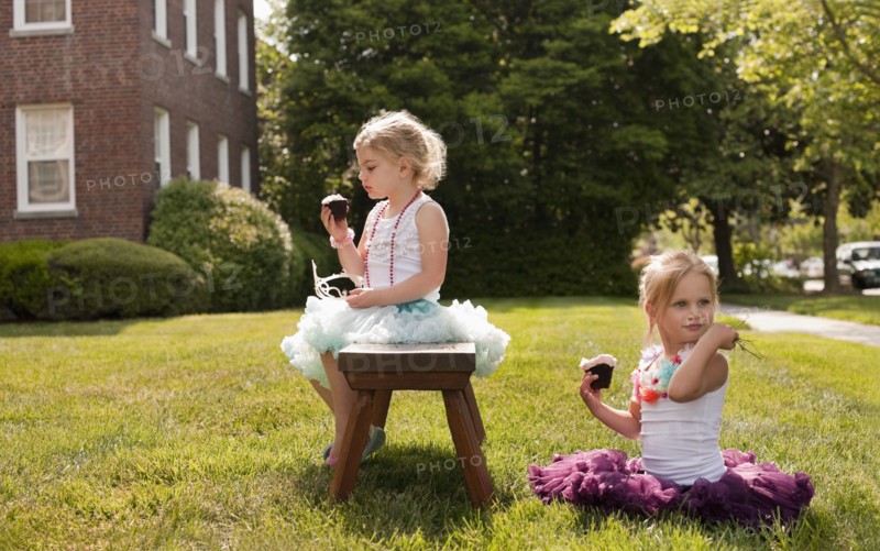 Caucasian girls playing dress up in yard