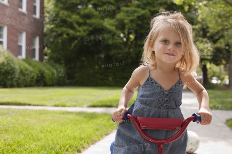 Caucasian girl riding bicycle