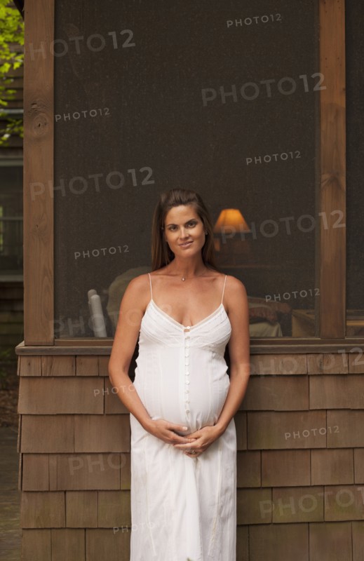 Pregnant Caucasian woman smiling outdoors