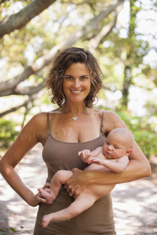 Caucasian mother holding baby outdoors