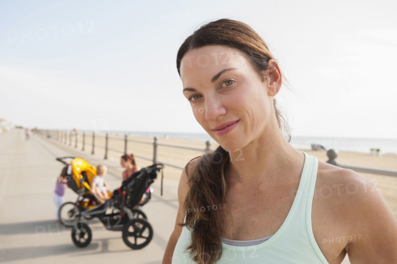 Caucasian woman smiling on beach boardwalk