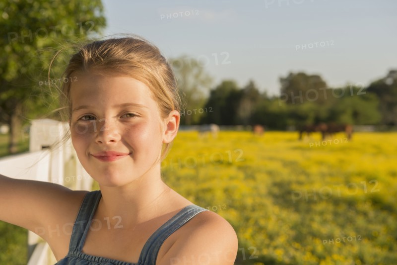 Caucasian girl smiling in rural landscape