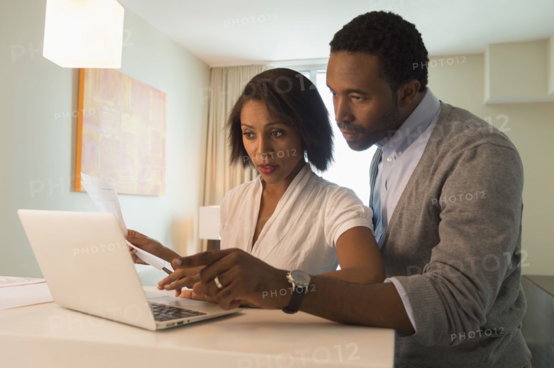 Couple paying bills on laptop