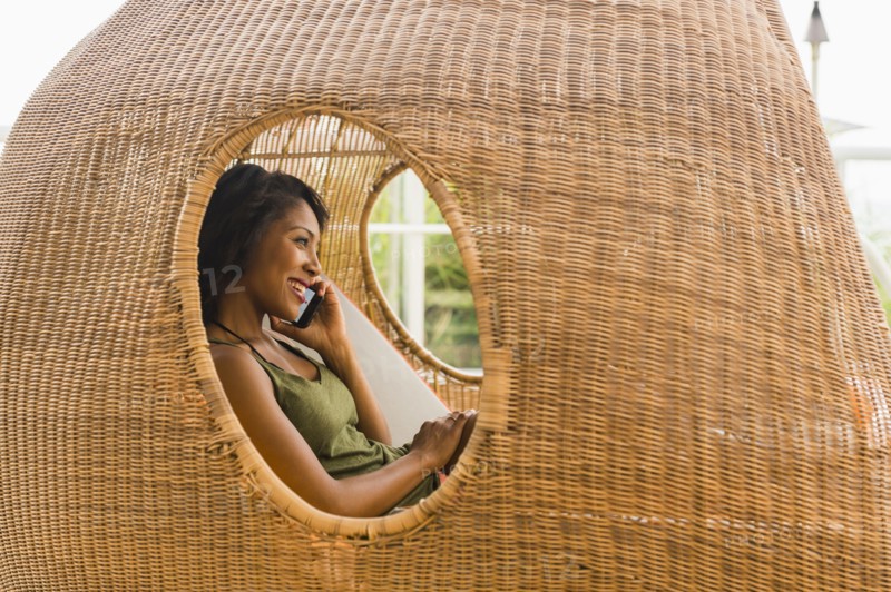 African American woman talking on cell phone in cabana